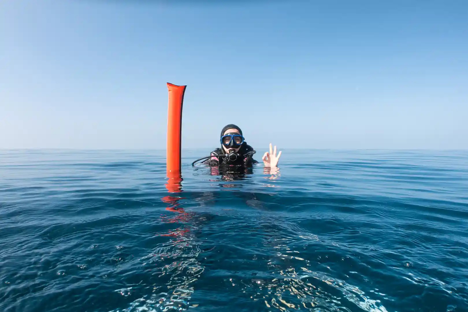 diver deploying surface marker buoy at sipadan